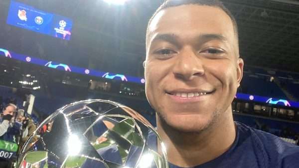 Kylian Mbappe cerebrates with a trohpy after a match
